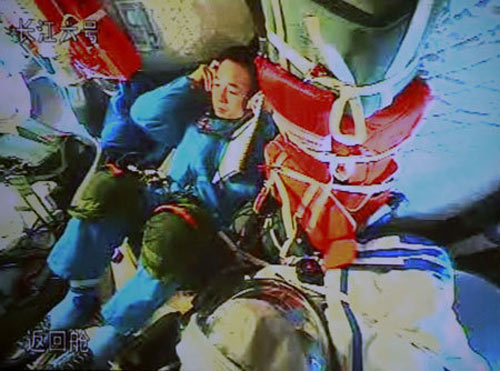 astronaut Jing Haipeng talks to the command and control center of Shenzhou VII