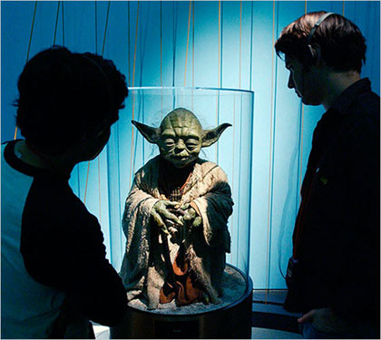 visitors inspect the puppet for Yoda, at the ‘Star Wars — The Magic of Myth’ exhibition in at the Brooklyn Museum of Art in 2002