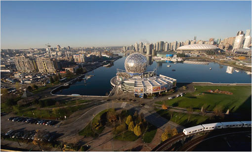 False Creek, with the 16-building Olympic Village to the left. At right is BC Place stadium where opening and closing ceremonies will take place. The Science World dome, center, was constructed for the 1986 World Exposition