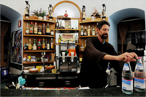 Friar Fausto tends Monastero S. Croce's bar