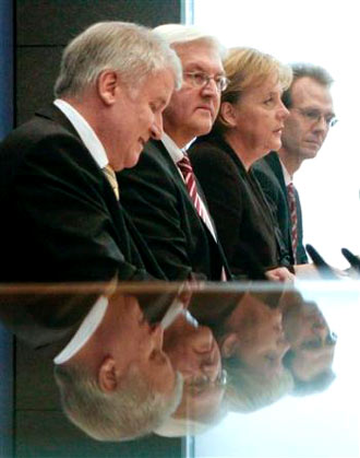 during a news conference in Berlin, from left, Christian Social Union Party chairman Horst Seehofer, Vice Chancellor and Foreign Minister Frank-Walter Steinmeier and German Chancellor Angela Merkel, and Peter Ehrlich, on Tuesday, Jan. 13, 2009, after the German coalition government agreed on a multibillion-euro economic stimulus package to help the country out of recession