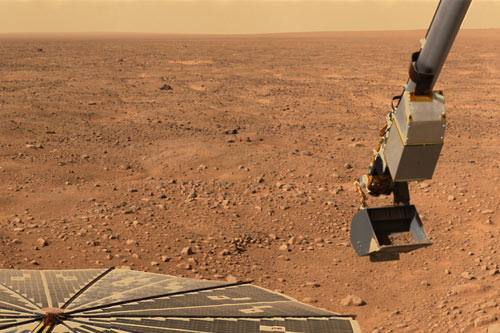 Mars' northern orange sky and horizon, seen by NASA's Phoenix Mars Lander, whose solar panel and Robotic Arm with a sample in the scoop are also visible