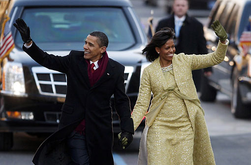 President Obama and his wife Michelle wave to the crowd as they walk down Pennsylvania Avenue in the Inauguration parade