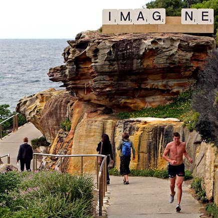 a jogger passes the timber and aluminium work ’IMAG_NE’ by Australian artist Emma Anna