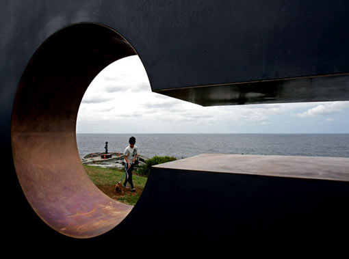 a boy walks his dog past the mild steel and bronze work ’She Thought’ by Australian artist Mark McClelland. The annual outdoor display features sculptures by 109 artists from eight countries and is expected to attract over 500,000 visitors before closing on November 2