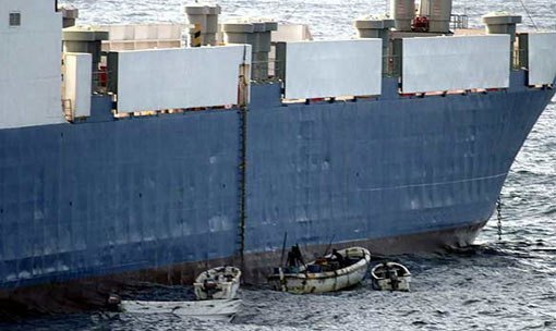 Somalis in small boats are seen alongside a hijacked Ukrainian ship off the coast of Somalia in this photo released Sept. 28, 2008 by the U.S. Navy