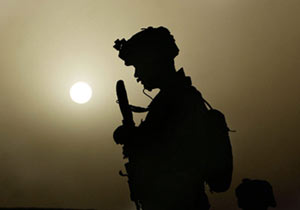 Marine speaks on radio during patrol in Helmand Province of Afghanistan