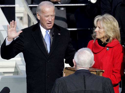 Vice President-elect Joe Biden takes the oath of office from Justice John Paul Stevens as Mr Biden’s wife Jill holds the Bible