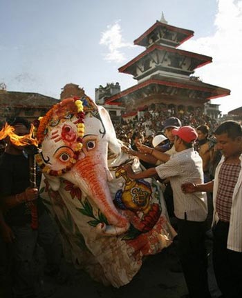 devotees dressed up as an elephant god perform rituals during the Indrajatra festival in Kathmandu September 14, 2008