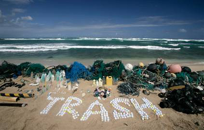 The word ‘trash’ is spelled out using golf balls retrieved by Greenpeace. Some of the other debris recovered during a cruise off Hawaii is displayed as well on Honolulu's Kahuku Beach.