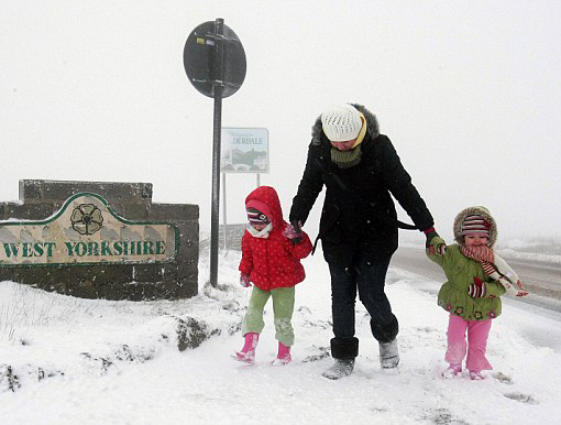 Brrrrr: A young family plays in the snow at Saddleworth, West Yorkshire as the driving snow turns the countryside white. Freezing temperatures and heavy snow sweep across Britain and much of Northern Europe. Michael Dukes, forecast manager for MeteoGroup UK, said the cold snap was set to continue for the next few days, although it was not yet known if milder weather would move in before or after Christmas. North-west England, the Pennines, Scotland and Northern Ireland saw the worst of the snow today. 'This is very cold Arctic weather from the North Sea,' he said.