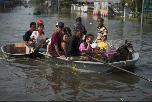 More than 300 people have been killed in floods throughout Northern Thailand from months of heavy monsoon rains. Local residents sit on a boat in floodwaters as they leave their homes with their animals and belongings in Bang Bua Thong in Nonthaburi province, suburban Bangkok, on Oct. 19, 2011.