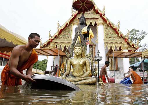 Buddhist monks collect their belongings at a flooded temple in the ancient city of Ayutthaya, Thailand, on October 7.