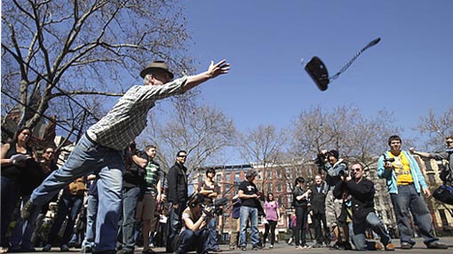 Howard Henson, an unemployed financial IT recruiter, tosses a phone during the Unemployment Olympics in New York, Tuesday, March 31, 2009