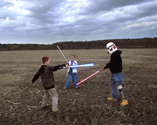 Raymond Hubbard, injured by a rocket in Baghdad in 2006, plays with his children in Darien, Wis. ‘Since his injuries, Raymond has become an avid collector of Star Wars merchandise. This is one of several family photos I took at his request.’