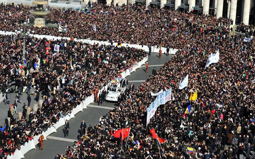 Pope Benedict waves as he arrives for his last weekly audience on St Peter's square at the Vatican