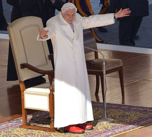 Pope Benedict waves from the altar as he arrives in St Peter's square for his last weekly audience